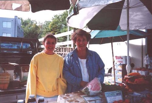 Farmer Kathy Caruso with a friend working at a farmer's market